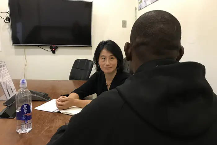 Lee Wang, of the New York Immigrant Freedom Fund, with Robert. The fund paid $20,000 to bond him out of immigration detention in New Jersey.